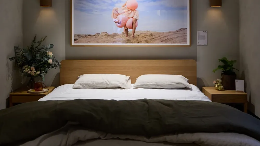 Eva Showroom – Where Style Meets Sleep Modern bedroom setup in the Eva showroom featuring a minimalist wooden bed.